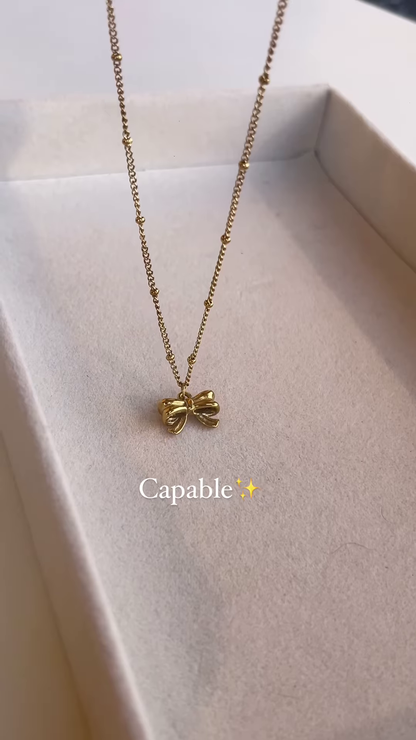 Elegant Gold-Toned Bow Pendant Necklace – Delicate and Charming